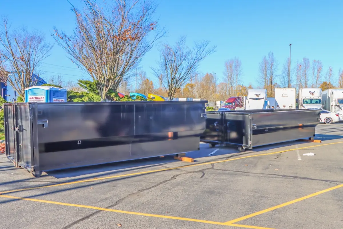 Professional dumpster rental service with roll-off container on residential driveway in Tomah